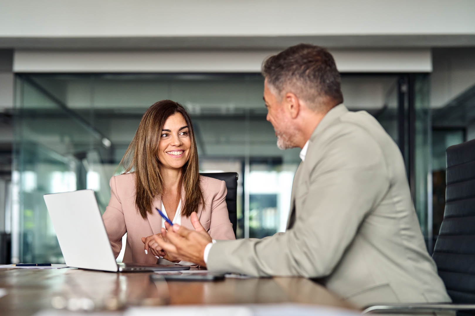 Professional property management executives discussing operations