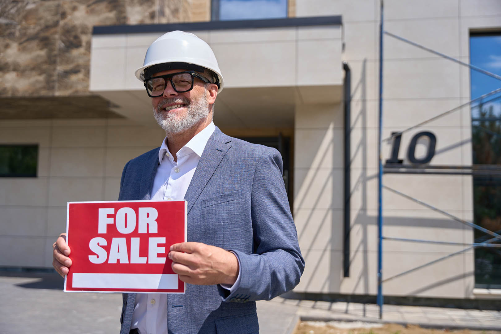 Professional in protective helmet managing property sales